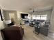Bright living room with a fireplace, a large sectional, and neutral decor at 3497 Birchwood Ct, Palm Harbor, FL 34684