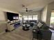 Comfortable living room with a sectional sofa, entertainment center, and a view of the outdoors at 3497 Birchwood Ct, Palm Harbor, FL 34684