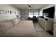 Relaxing main bedroom featuring a spacious layout, a large window, and a ceiling fan at 3497 Birchwood Ct, Palm Harbor, FL 34684
