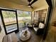 Comfortable screened patio with tiled floors, seating, and a view of the backyard at 3497 Birchwood Ct, Palm Harbor, FL 34684