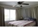 Comfortable bedroom with neutral-colored decor, bright window, and a ceiling fan at 3710 98Th N Ave, Pinellas Park, FL 33782
