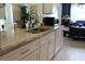 Bright kitchen featuring granite countertops, white cabinetry, stainless steel sink, and modern appliances for functionality at 3710 98Th N Ave, Pinellas Park, FL 33782