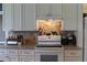 Functional kitchen featuring granite countertops, white cabinetry, stainless steel appliances, and tile backsplash for enhanced convenience at 3710 98Th N Ave, Pinellas Park, FL 33782