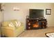 Cozy living room featuring a love seat and fireplace with a mounted TV, creating a relaxing atmosphere at 3710 98Th N Ave, Pinellas Park, FL 33782