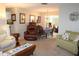 Open-concept living room leads to dining area, complete with a brown recliner at 3710 98Th N Ave, Pinellas Park, FL 33782