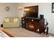 Cozy living room featuring a love seat and fireplace with a mounted TV, creating a relaxing atmosphere at 3710 98Th N Ave, Pinellas Park, FL 33782