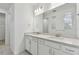 Bright bathroom featuring a double vanity with white cabinets and a large mirror at 37252 Clinch Cir, Zephyrhills, FL 33540