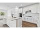 Modern kitchen featuring an island, stainless steel appliances, and white cabinetry at 37252 Clinch Cir, Zephyrhills, FL 33540