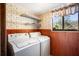 Functional laundry room with washer, dryer, built in shelving, and window at 404 Craft Rd, Brandon, FL 33511