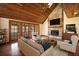 Inviting living room with a stone fireplace, wood ceiling, and doors to the outside at 404 Craft Rd, Brandon, FL 33511
