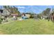 Expansive backyard featuring lush lawn, mature trees, and a greenhouse at 4108 Berkley Dr, Tampa, FL 33610