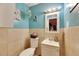 Bright bathroom with blue walls, a vanity, a toilet, and tiled shower at 4108 Berkley Dr, Tampa, FL 33610