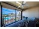 Enjoy partial ocean views from this inviting balcony with table and chairs at 4450 Gulf Blvd # 303, St Pete Beach, FL 33706