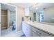 Bright bathroom featuring a granite countertop, white cabinets, and tiled flooring at 4450 Gulf Blvd # 303, St Pete Beach, FL 33706
