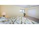 Well-lit bedroom featuring a tropical-themed comforter, and a spacious closet at 4450 Gulf Blvd # 303, St Pete Beach, FL 33706