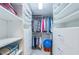 Walk-in closet with custom shelving providing ample storage and organization at 4450 Gulf Blvd # 303, St Pete Beach, FL 33706
