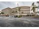 Exterior of a well-maintained beach condo building with palm trees and parking at 4450 Gulf Blvd # 303, St Pete Beach, FL 33706
