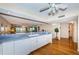 Bright kitchen with white cabinets, hardwood floors, and serving area at 4450 Gulf Blvd # 303, St Pete Beach, FL 33706