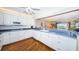 Kitchen featuring white cabinets, hardwood floors, and an ocean view at 4450 Gulf Blvd # 303, St Pete Beach, FL 33706