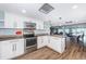 Bright kitchen complete with stainless steel appliances and modern countertops with access to the lounge at 4450 Gulf Blvd # 303, St Pete Beach, FL 33706