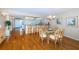 Open living space with a view of kitchen bar, dining table and entrance door at 4450 Gulf Blvd # 303, St Pete Beach, FL 33706