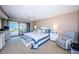Serene main bedroom with balcony access offering ocean views, creating a peaceful retreat at 4450 Gulf Blvd # 303, St Pete Beach, FL 33706