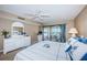 Bright main bedroom with a beautiful dresser and a balcony with ocean views at 4450 Gulf Blvd # 303, St Pete Beach, FL 33706