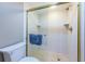 Modern shower enclosed with glass doors, showcasing clean tile work and sleek fixtures at 4450 Gulf Blvd # 303, St Pete Beach, FL 33706