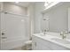 Bright bathroom with double vanity, large mirror, and a shower-over-tub featuring white subway tile at 4535 Foley Grove Dr, Valrico, FL 33596