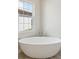 Bright bathroom showcasing a standalone tub near a window at 4535 Foley Grove Dr, Valrico, FL 33596