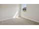 Bedroom featuring neutral carpet, window, and white trim at 4535 Foley Grove Dr, Valrico, FL 33596