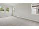 Spacious bedroom featuring neutral carpet, lots of natural light, and a tray ceiling at 4535 Foley Grove Dr, Valrico, FL 33596