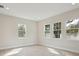 Bright bedroom featuring three windows providing ample natural light and hard surface flooring at 4535 Foley Grove Dr, Valrico, FL 33596