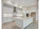An elegant kitchen showcases a central island, quartz countertops, and stainless steel appliances at 4535 Foley Grove Dr, Valrico, FL 33596