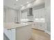 Elegant kitchen with an island featuring white cabinets and stainless steel appliances at 4535 Foley Grove Dr, Valrico, FL 33596