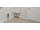 An utility sink with a door and tile floor in a well-lit laundry room at 4535 Foley Grove Dr, Valrico, FL 33596
