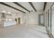Large open living area with tiled floor, beamed ceilings, and kitchen in view at 4535 Foley Grove Dr, Valrico, FL 33596