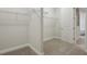 Carpeted walk-in closet featuring metal shelving and plenty of storage at 4535 Foley Grove Dr, Valrico, FL 33596