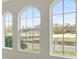 Three arched windows with views of neighborhood at 4535 Foley Grove Dr, Valrico, FL 33596