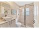 Bathroom featuring modern vanity, glass enclosed shower, and neutral color scheme at 4579 Del Sol S Blvd, Sarasota, FL 34243