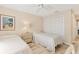 Cozy bedroom with two twin beds, ceiling fan, and white closet doors at 4579 Del Sol S Blvd, Sarasota, FL 34243