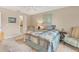 Bedroom featuring neutral paint, travertine floors, and comfortable furnishings at 4579 Del Sol S Blvd, Sarasota, FL 34243