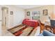 Bedroom with a large window, area rug, closet with louvered doors, and adjacent desk area at 4579 Del Sol S Blvd, Sarasota, FL 34243