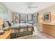 Comfortable bedroom with a ceiling fan, ensuite bathroom, sliding glass doors, and a large dresser with a nice rug at 4579 Del Sol S Blvd, Sarasota, FL 34243