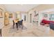 Bright dining area with tile floors, modern light fixture, and an open entryway to another living space with a nice painting at 4579 Del Sol S Blvd, Sarasota, FL 34243