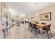 Open-concept dining room showcasing travertine floors, neutral paint, and easy flow to living area at 4579 Del Sol S Blvd, Sarasota, FL 34243