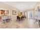 Open dining area featuring tile floors, modern lighting, and an adjacent kitchen at 4579 Del Sol S Blvd, Sarasota, FL 34243