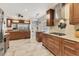 Gourmet kitchen with custom wood cabinets, stainless appliances, granite counters, and a tile backsplash with tile floors at 4579 Del Sol S Blvd, Sarasota, FL 34243
