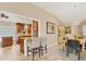 The kitchen offers a charming breakfast bar that connects the dining area to the kitchen. Plenty of artwork at 4579 Del Sol S Blvd, Sarasota, FL 34243