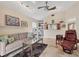 Cozy living room with natural light, built-in shelving, neutral paint, tile floors, and comfortable seating furniture at 4579 Del Sol S Blvd, Sarasota, FL 34243